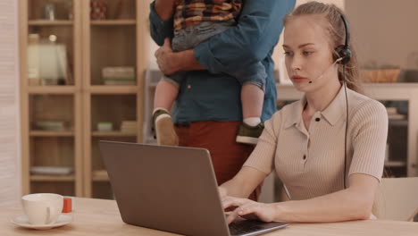 Partner with Kid Distracting Working Woman