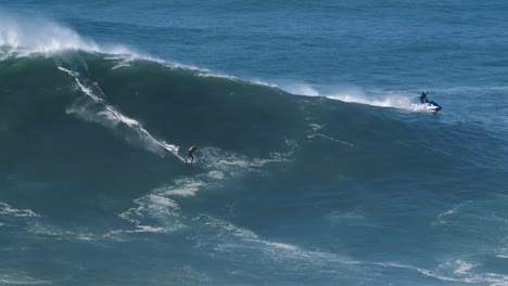 slow motion of a big wave surfer riding a crazy wave in nazaré, portugal