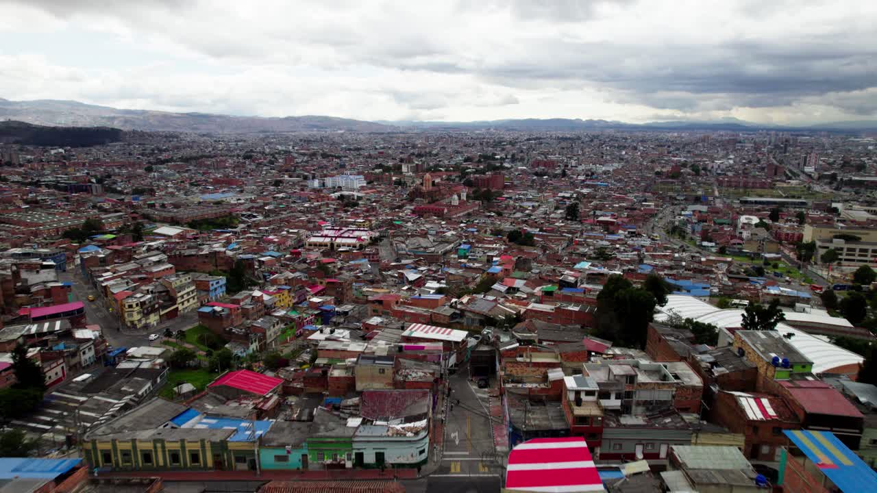 Aerial Establishing Shot of Colourful Slums in Bogota, Columbia, Moody Clouds