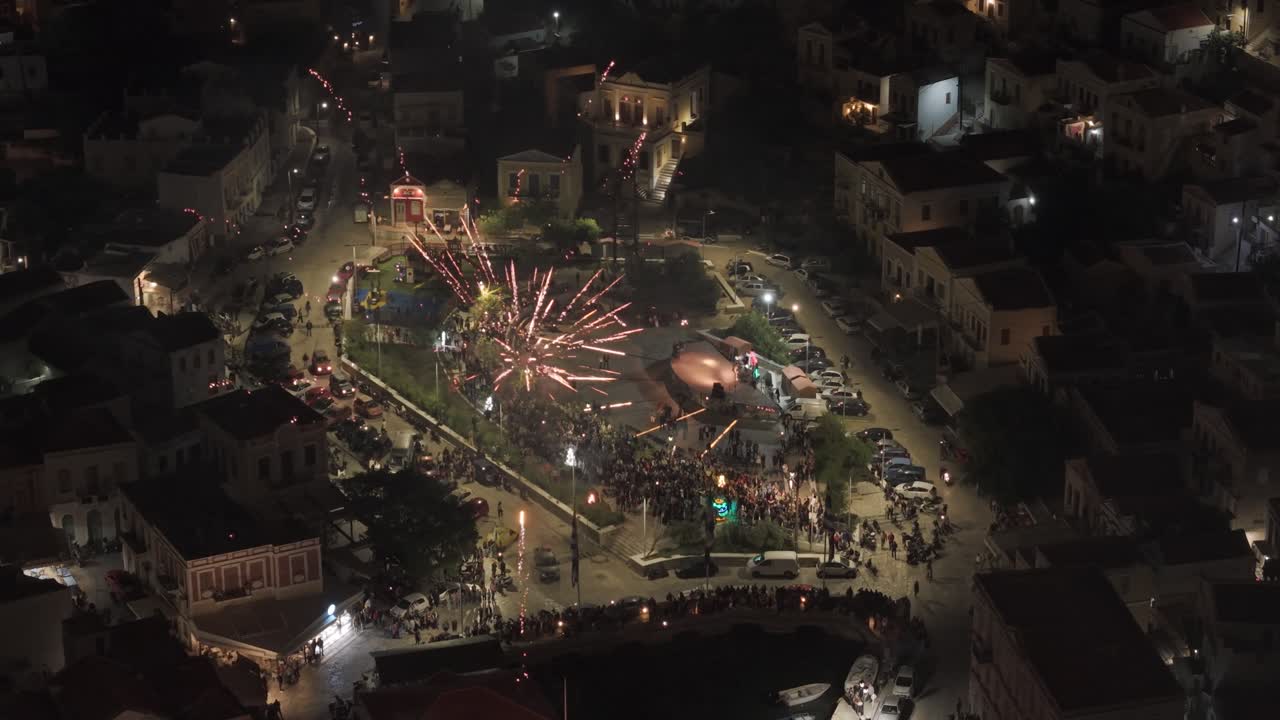 Dynamic footage of spectacular fireworks celebration filmed from multiple angles in Symi over Mediterranean harbor. Filmed with 3x telephoto D-Log M