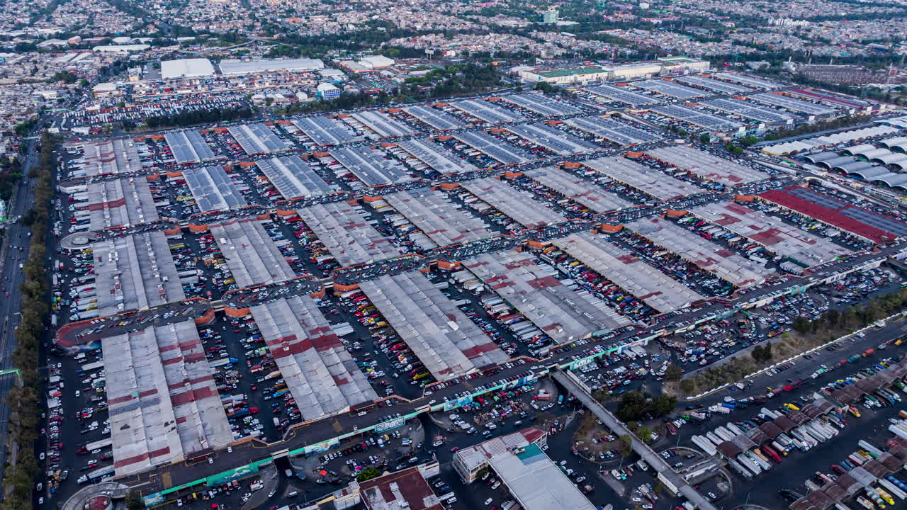 Drone timelapse of Central de Abasto, Mexico City’s largest wholesale market, showcasing vast warehouse structures and heavy activity.