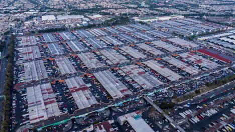 drone timelapse of central de abasto, mexico city’s largest wholesale market, showcasing vast warehouse structures and heavy activity.