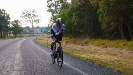 close up of athlete cyclist riding road bike in countryside, 4k