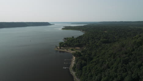boat jetty on the bank of mississippi river with calm waters in frontenac state park in minnesota, usa