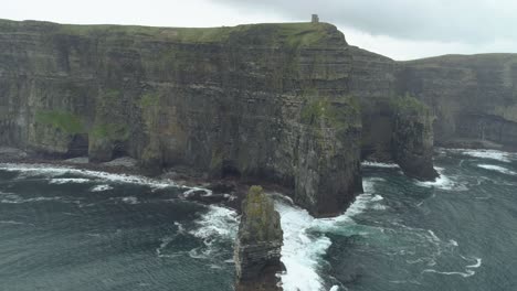 aerial turning shot of epic thrilling lanscape coastline cliffs at cliffs of moher ireland