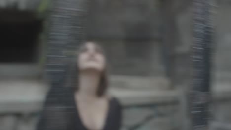 Slow-motion-shot-of-blurred-woman-inside-an-animal-cage