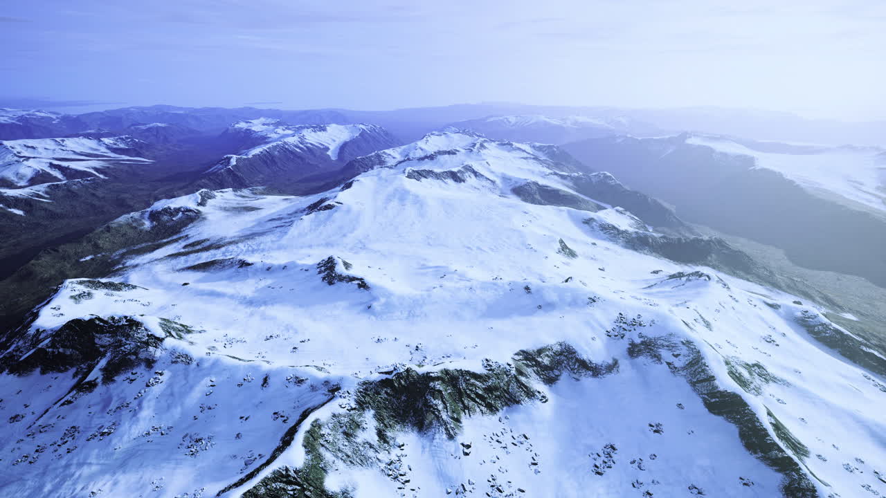 Snow covered mountain range under a clear sky during daylight hours