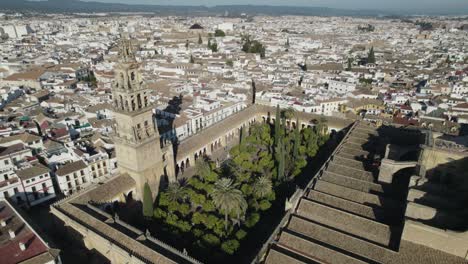 orbiting view of mosque-cathedral of cordoba and iconic garden, patio de los naranjos. spain