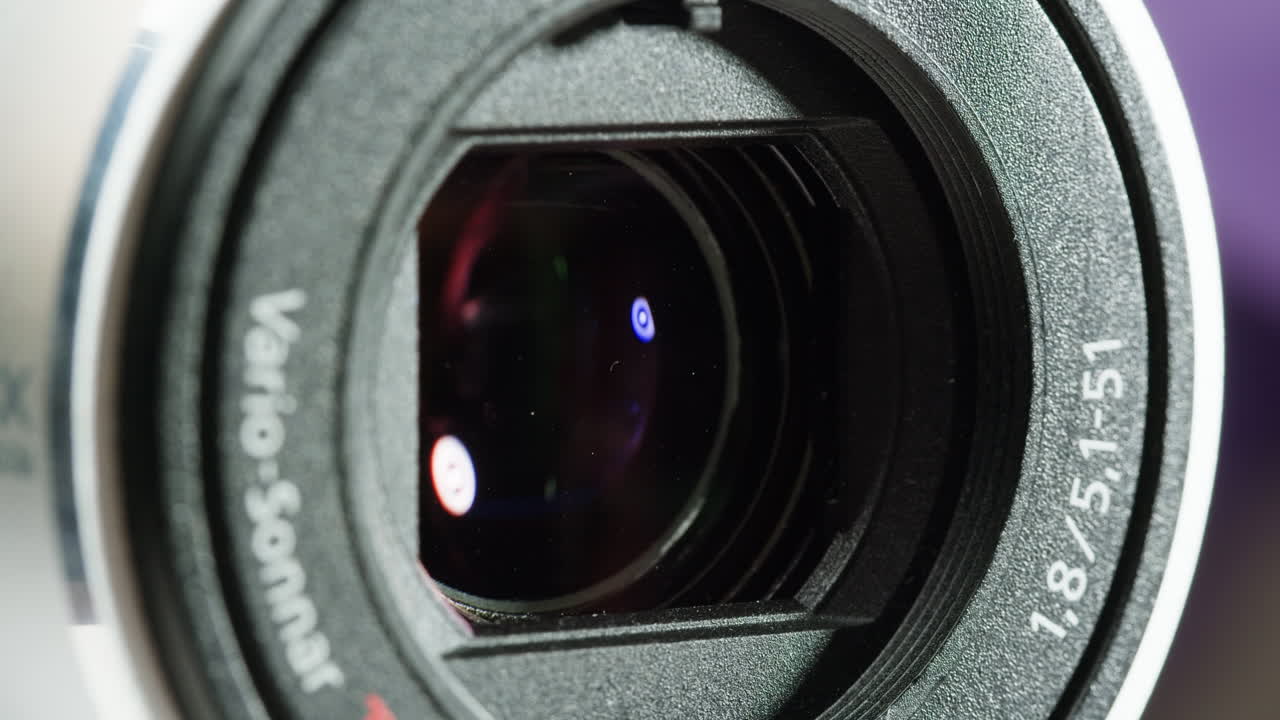Close-up of Vintage video-camera. Close and open lens zoom of camera. Using portable camcorder to shooting videos