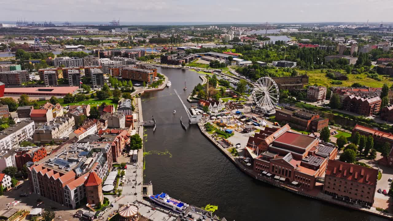 Cinematic aerial Gdansk Stara Motlawa with yachts, Ferris wheel and city harbor