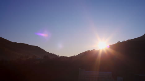 Time-Lapse-of-a-sunrise-and-fog-over-the-mountains-in-the-small-village-of-Montan,-in-the-Community-of-Valencia,-Spain