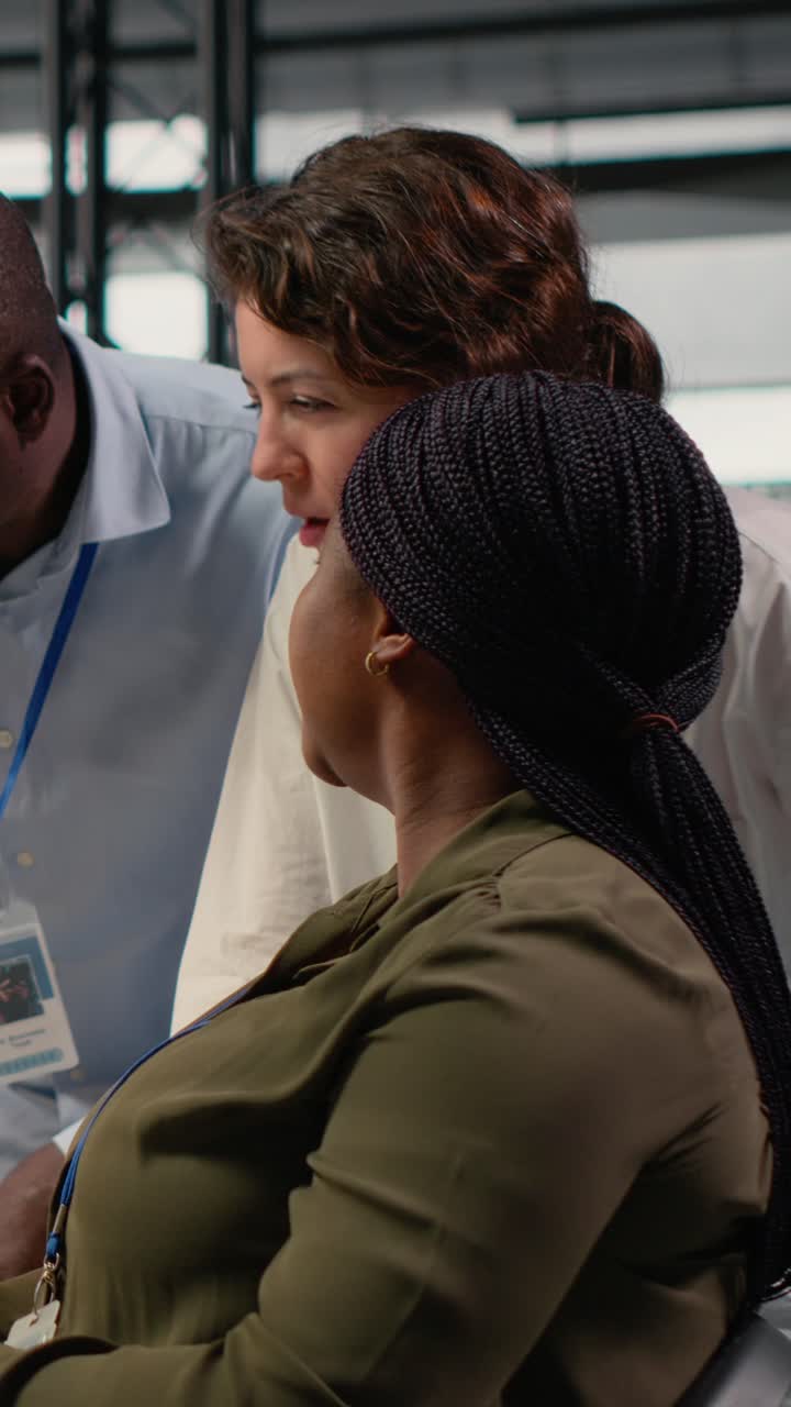 Vertical video Multiethnic technicians in startup office work with artificial intelligence