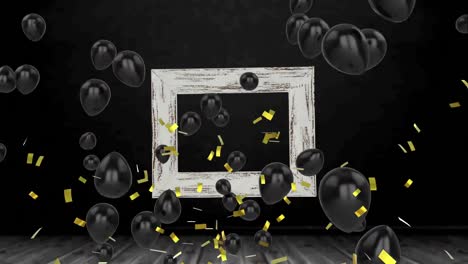 Golden-confetti-falling-and-multiple-black-balloons-floating-against-a-frame-on-black-background