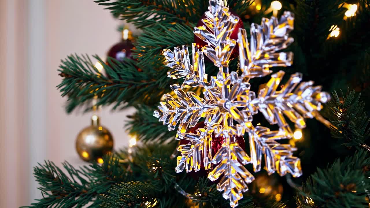 Close-up video of a Christmas tree adorned with sparkling ornaments and lights, captured from a side