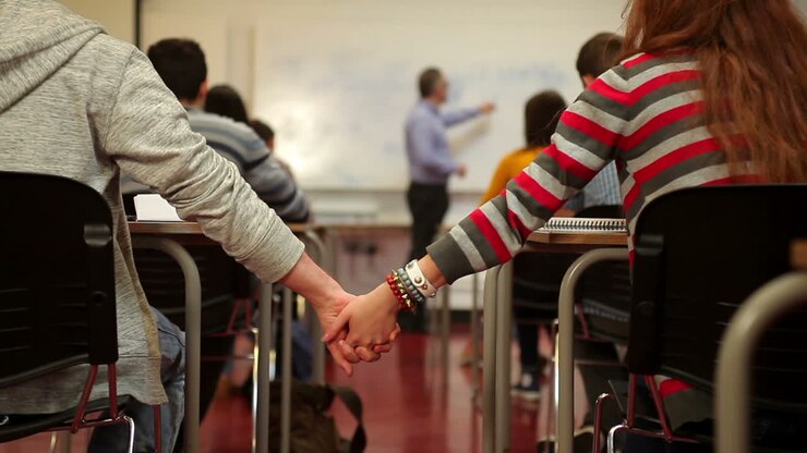 Students holding hands in class