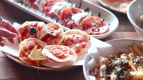 mini pizzas y papas fritas servidas en una mesa