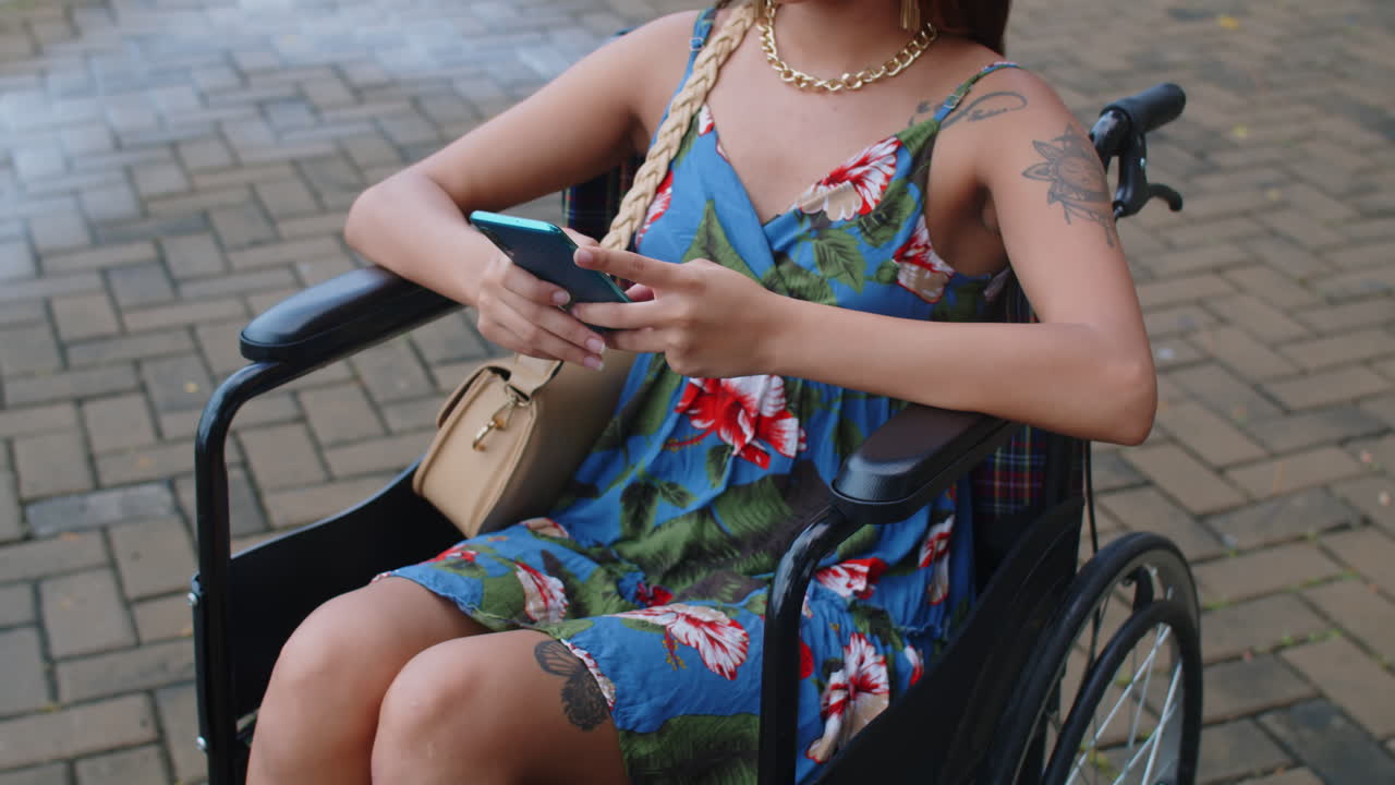 Woman in Wheelchair Chatting on Mobile Phone