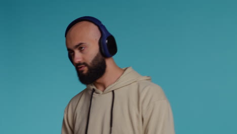 middle eastern having fun listening to music on headset