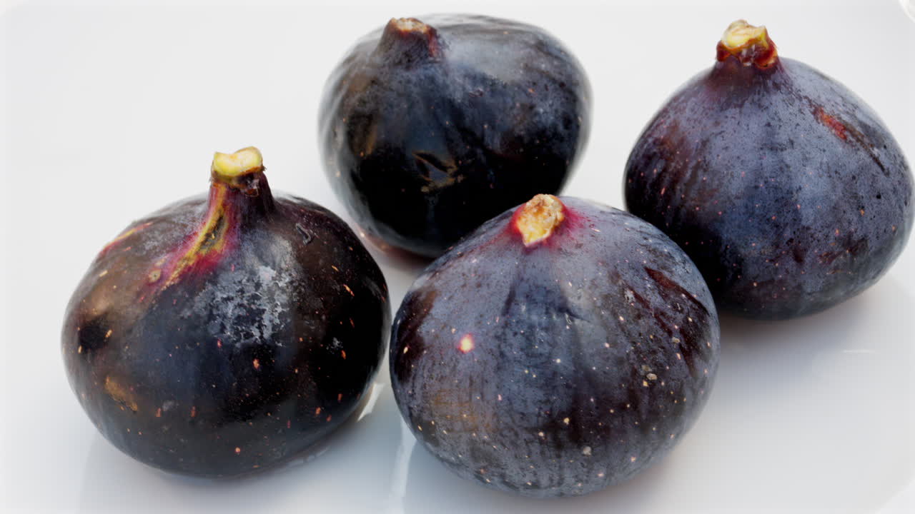 Close up of ripe figs on a white plate