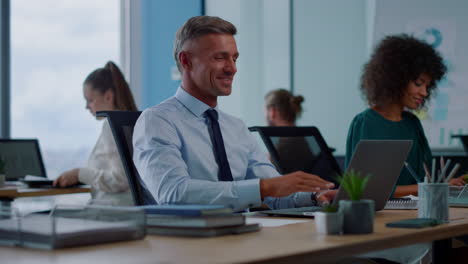 Bussiness man sending air kiss at laptop camera