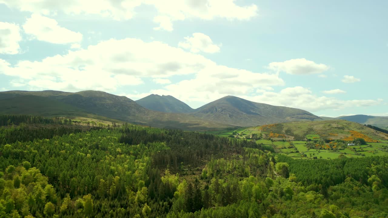 Expansive aerial video of the Mourne Mountains and Slieve Donard in Newcastle, County Down in Northern Ireland, UK on a bright and sunny day. Filmed in 4K, 60fps and with Rec709 Color.
