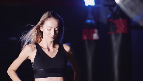 slow motion of confident young woman tossing hair in gym