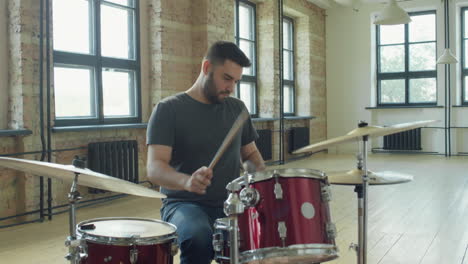 professional drummer practicing drumset in studio
