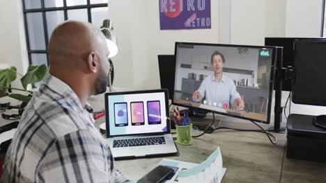 African-american-businessman-on-video-call-with-caucasian-male-colleague-on-screen