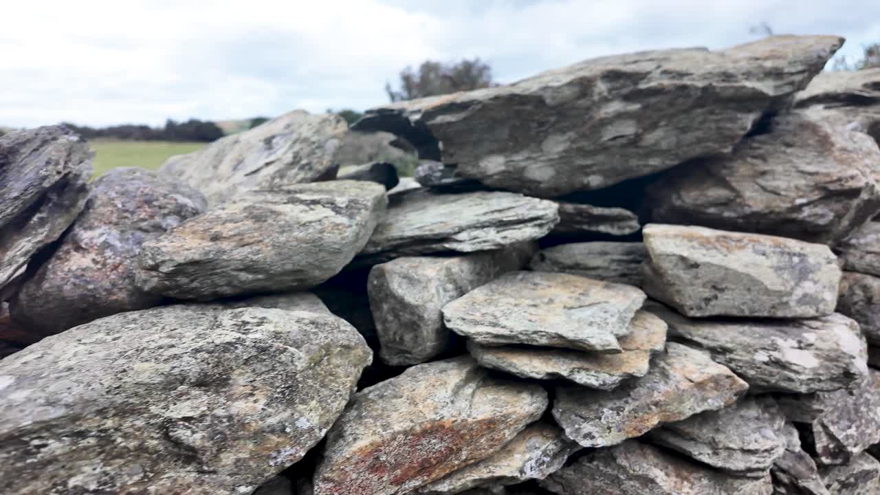 Robust stone wall forming a barrier in a wide open field