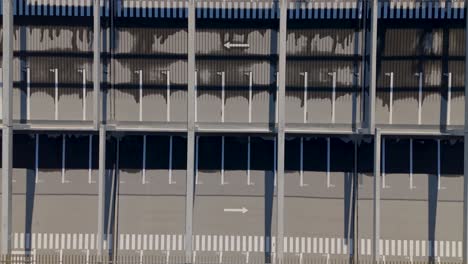 multi-storeyed parking lot in neighborhood with meticulously organized concrete structure