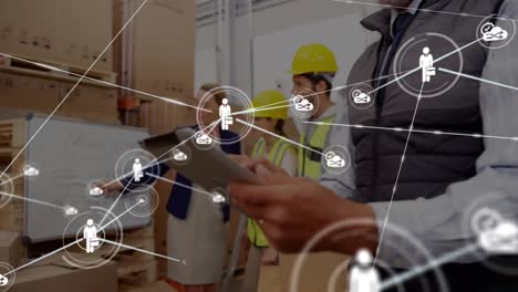 Animation-of-network-of-connections-with-icons-over-diverse-workers-in-warehouse