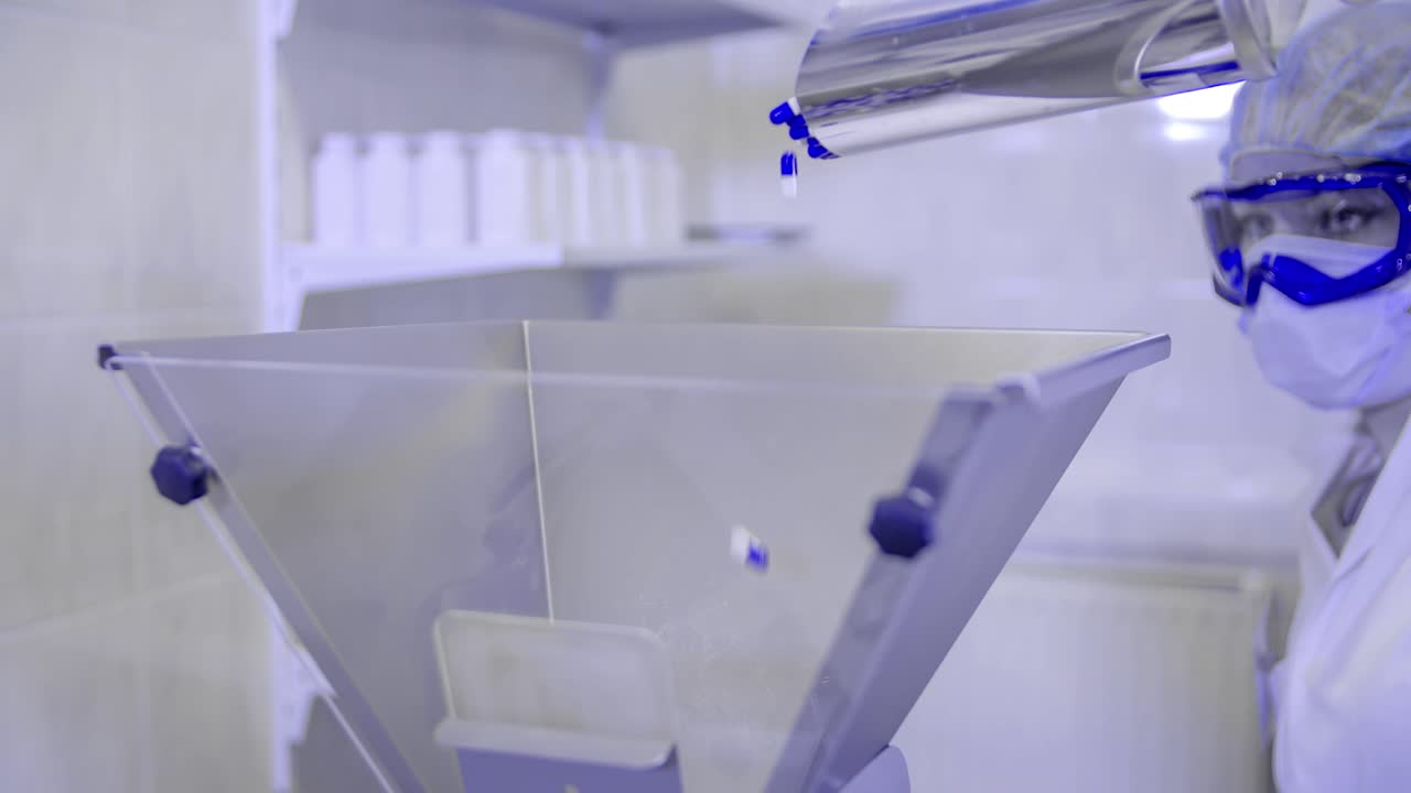 Nurse throws coronavirus medicine pills into a bucket. Covid-19 protection suit. Pandemic