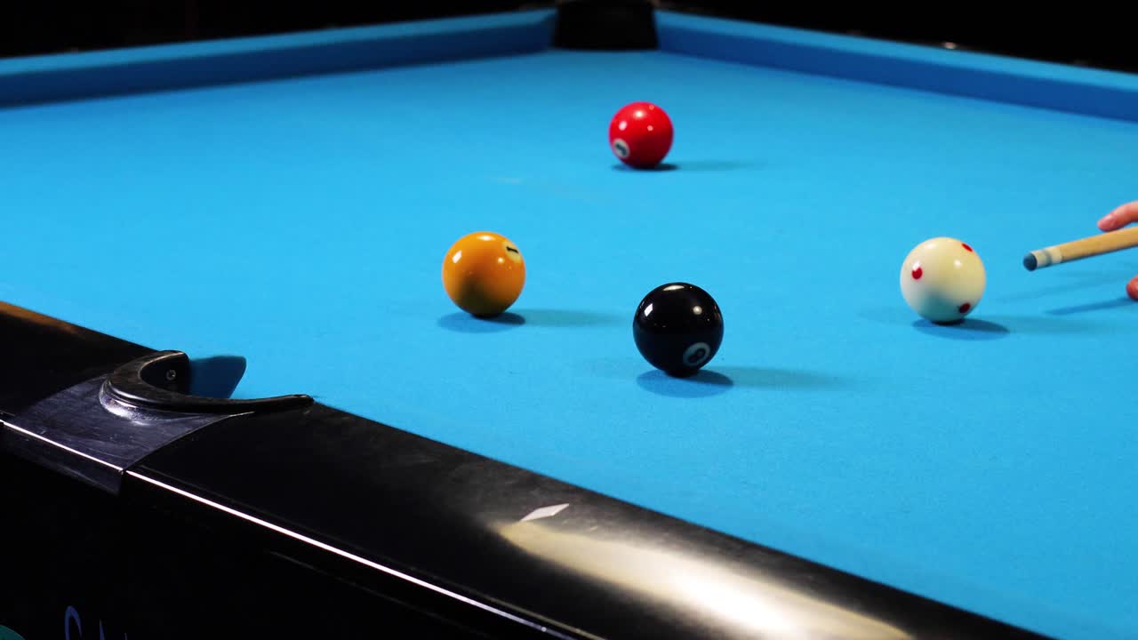 Playing a match of pool billiards hitting black ball winning the game