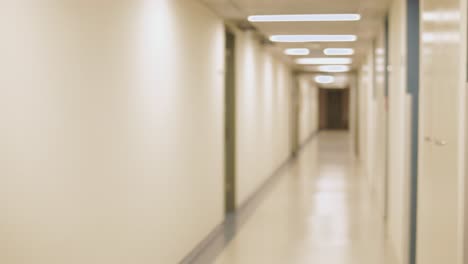 young middle eastern woman typing fast text message on a smartphone in hallway