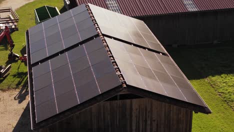Cinematic-aerial-footage-of-farm-building-with-fitted-solar-panels