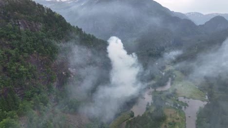 forest wildfire after lightning strike - aerial showing smoke from burning forest due to warm climate - stamneshella norway europe