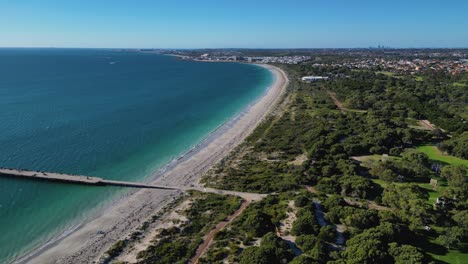 aerial drone forward moving shot over coogee beach jetty on a summers day in perth, western australia at daytime