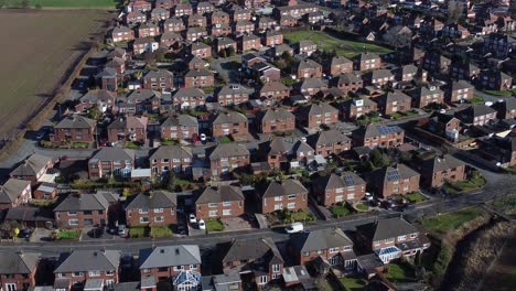 typical suburban village residential scottish neighbourhood property rooftops aerial view slow descend