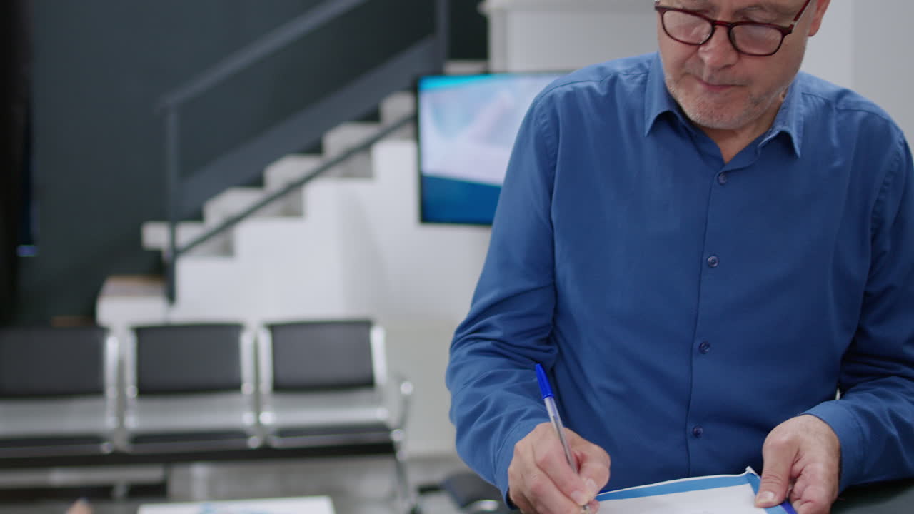 A patient filling a form at the reception