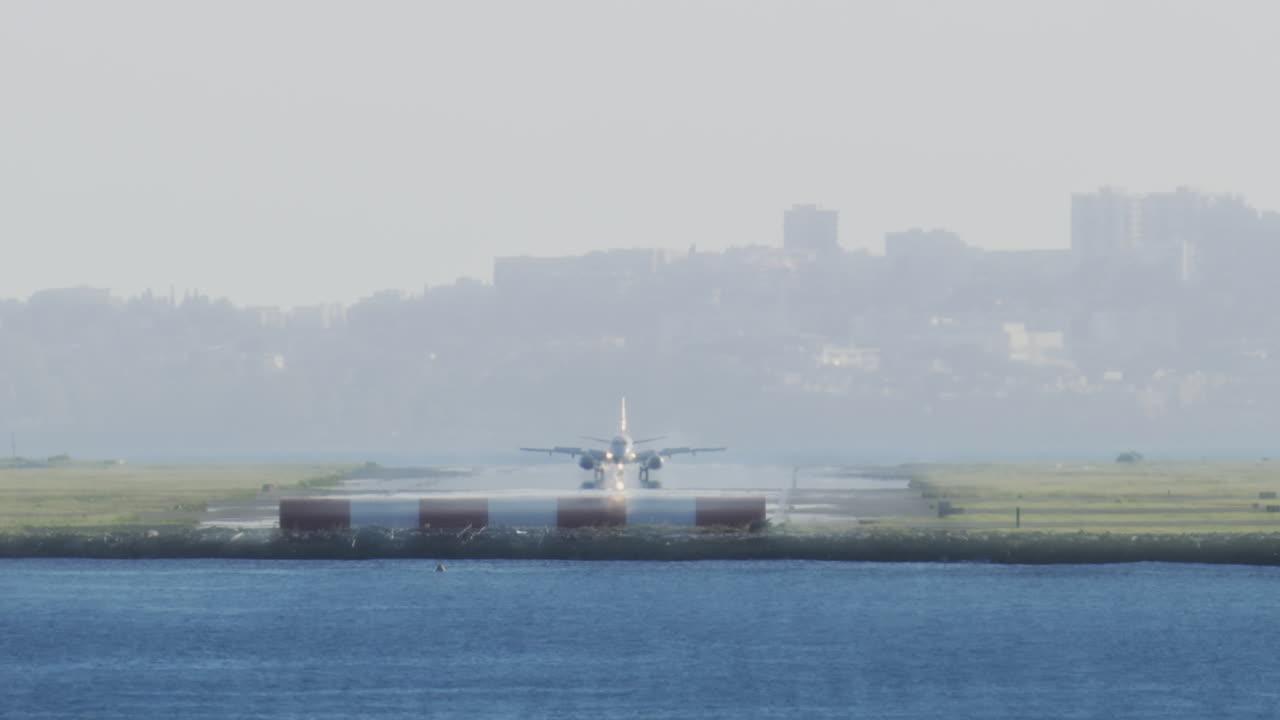 Distant view of airplanes landing at the Nice Cote d'Azur Airport in daylight