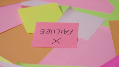 business concept of revolving sticky notes with failure written on top note 1