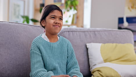 Girl-child,-remote-and-watching-tv-on-sofa