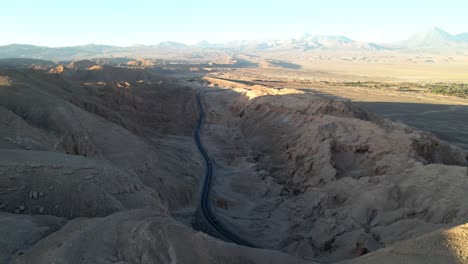 drone hovers over atacama, volcan licancabur, displaying the highway with some traffic