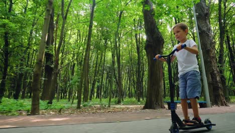 a boy rides a scooter in a city park 06