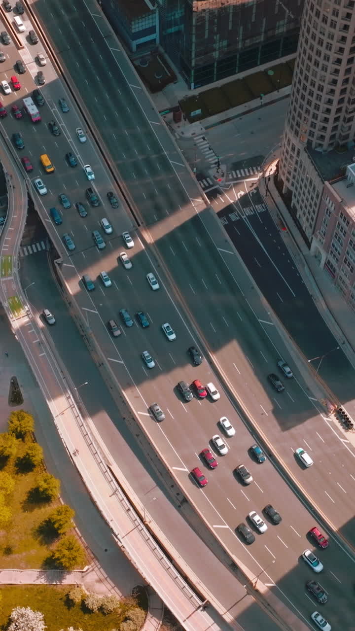 Chicago traffic on sunny autumn day. Busy multi-lane roads going through a huge city. Bird's eye view. Vertical video