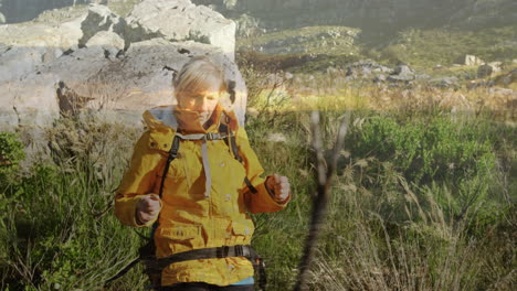 animation of caucasian woman hiking with backpack over landscape