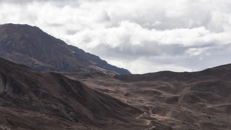 a time-lapse zoom video of clouds moving over the rugged desert himalaya mountains in nepal