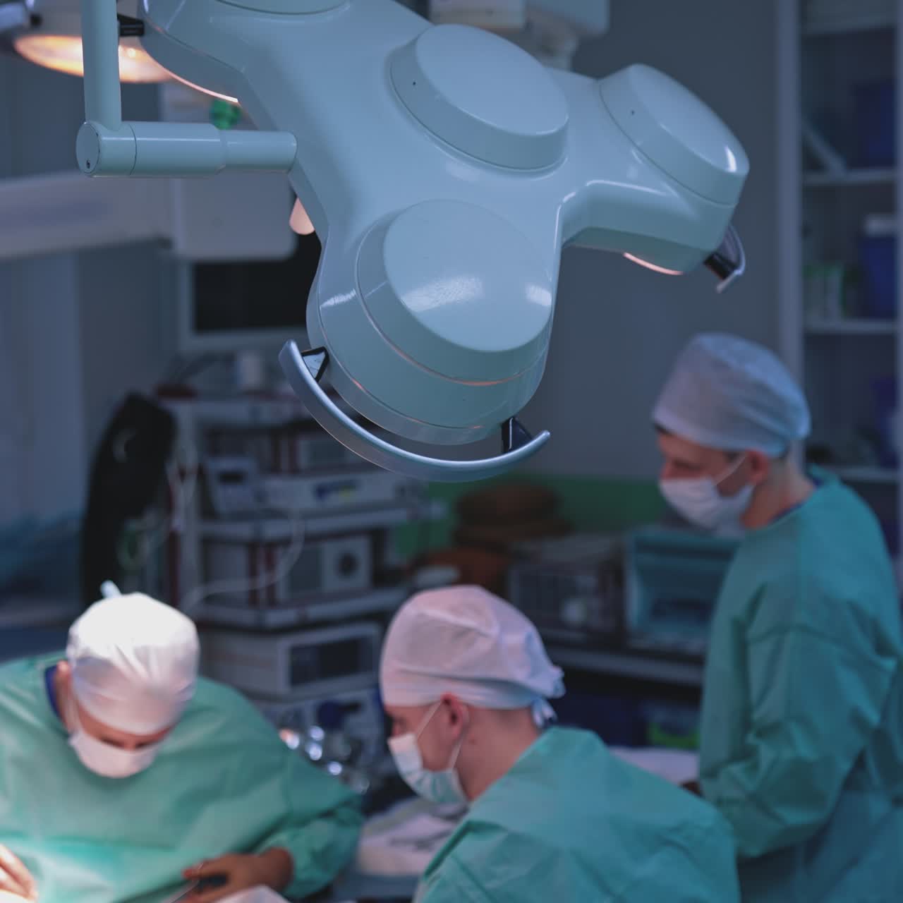 Surgical liposuction tummy tuck. Team of surgeons doing plastic surgery in modern clinic. Medicine concept. High angle view