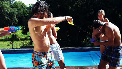 Happy-friends-doing-water-gun-battle