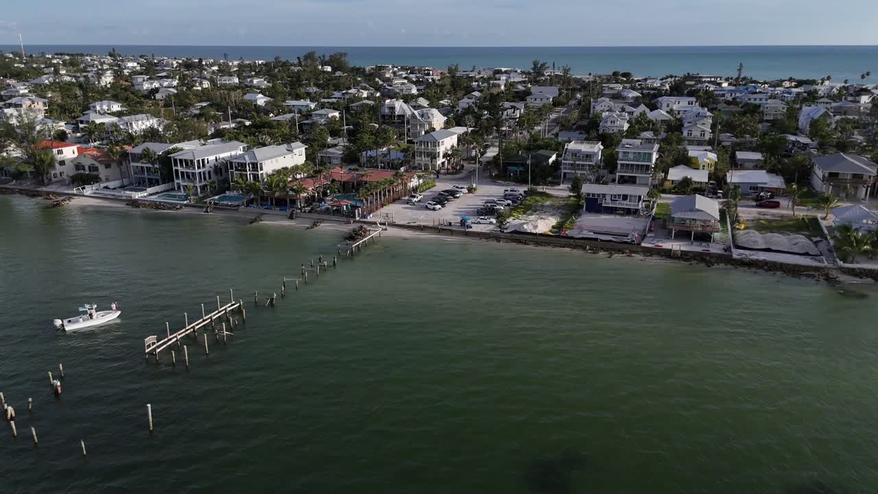 fishing boat near a damaged public dock on Anna Maria Island, interior side channel